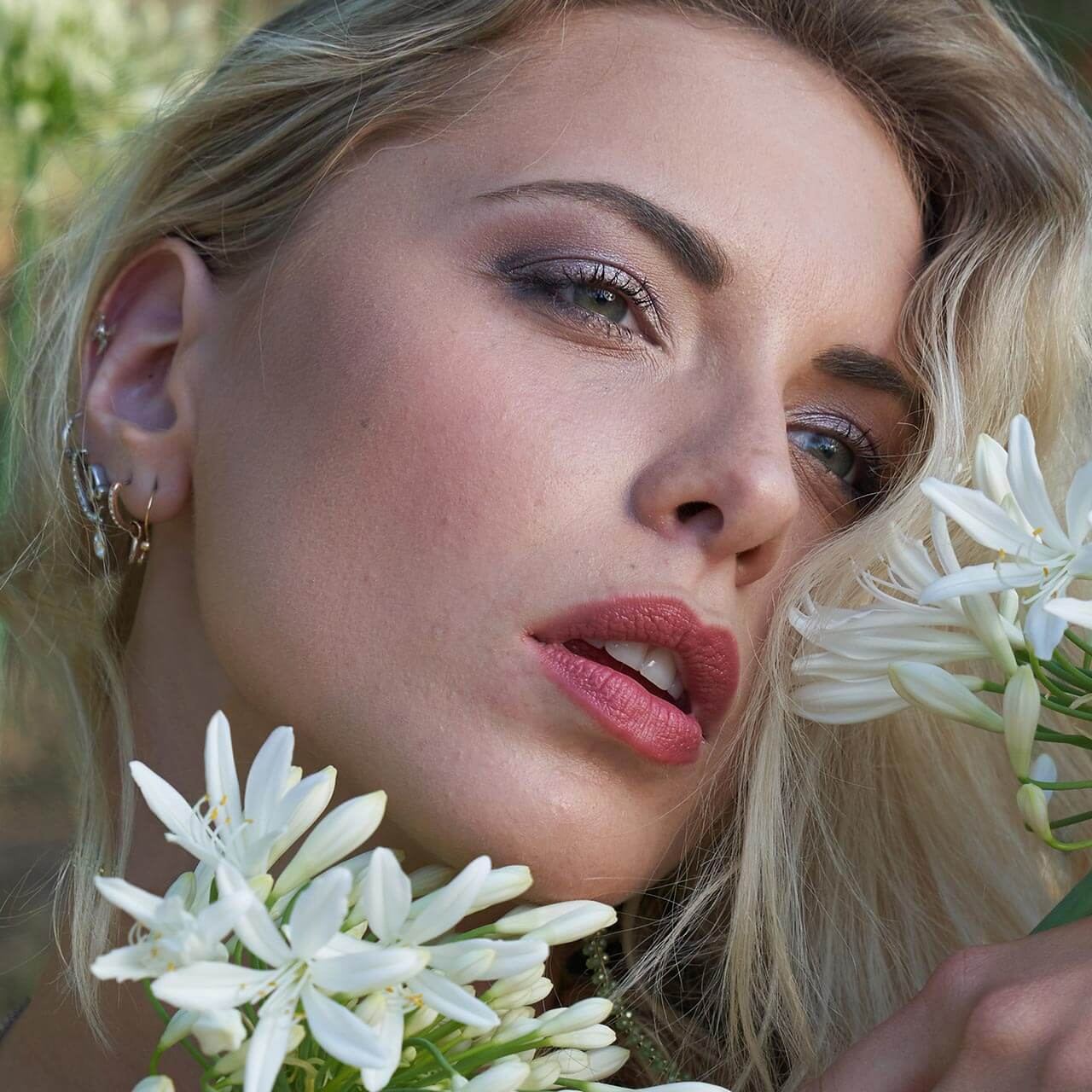 Before: Portrait of a blonde woman with white flowers