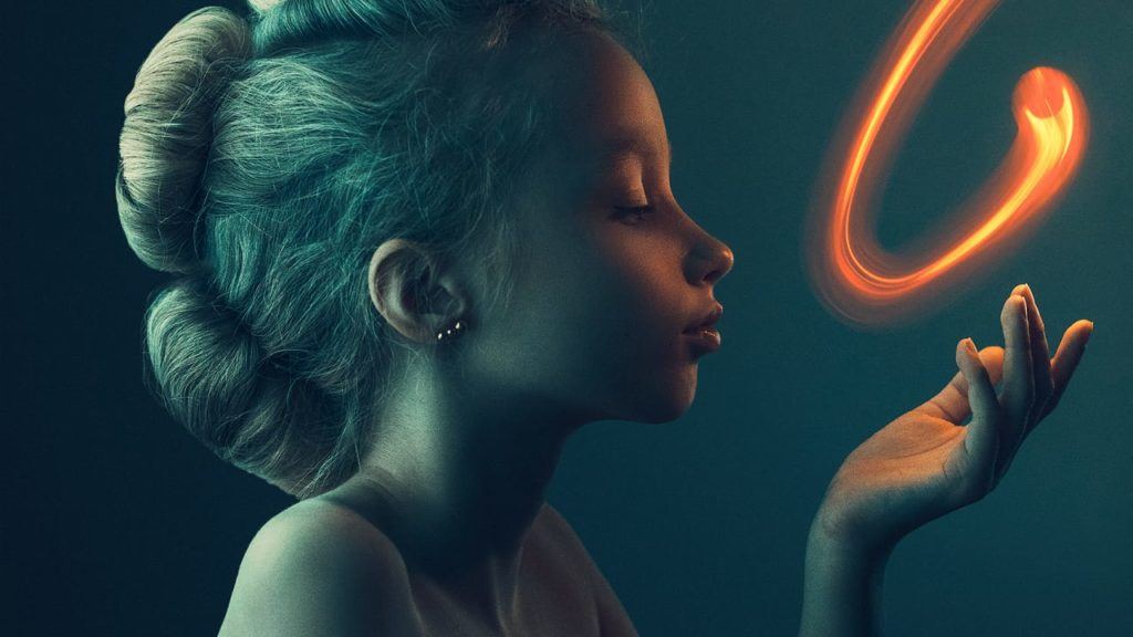 Profile portrait of a child with teal-tinted hair and a glowing orange light streak above an open hand